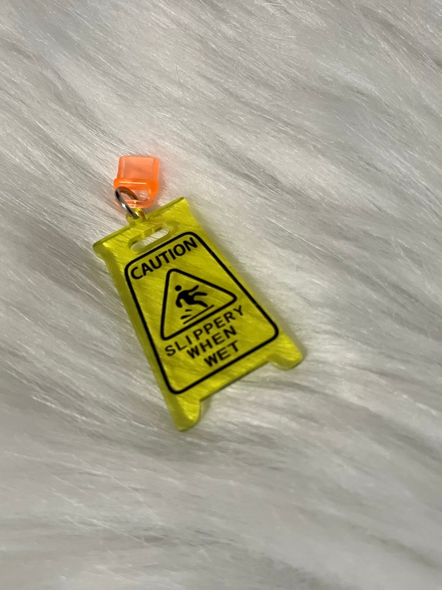 Caution Slippery Dust Plug Charm